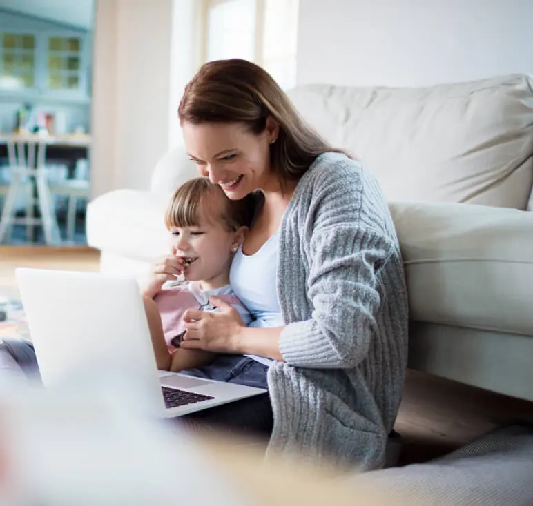 Woman with child looking at laptop